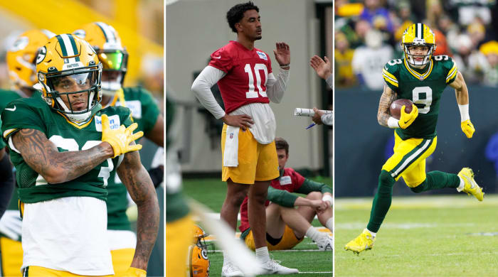 Cornerback Jaire Alexander taps his shoulder; quarterback Jordan Love stands with his hands on his hips; WR Christian Watson runs with the ball